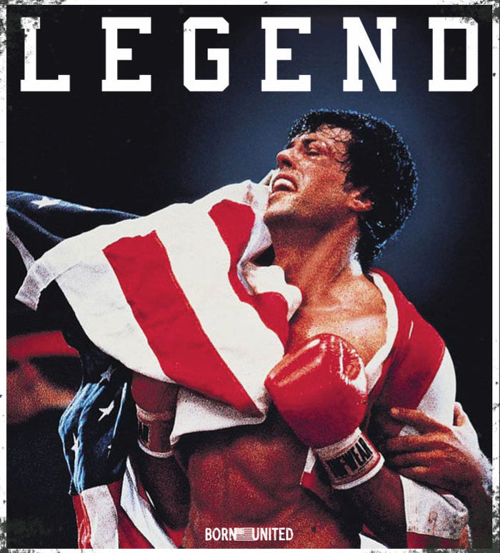 A victorious boxer draped in an American flag and red gloves smiles under the bold โLEGENDโ text. This is featured on Born United Private Labelโs Legend - Balboa PVC Patch.