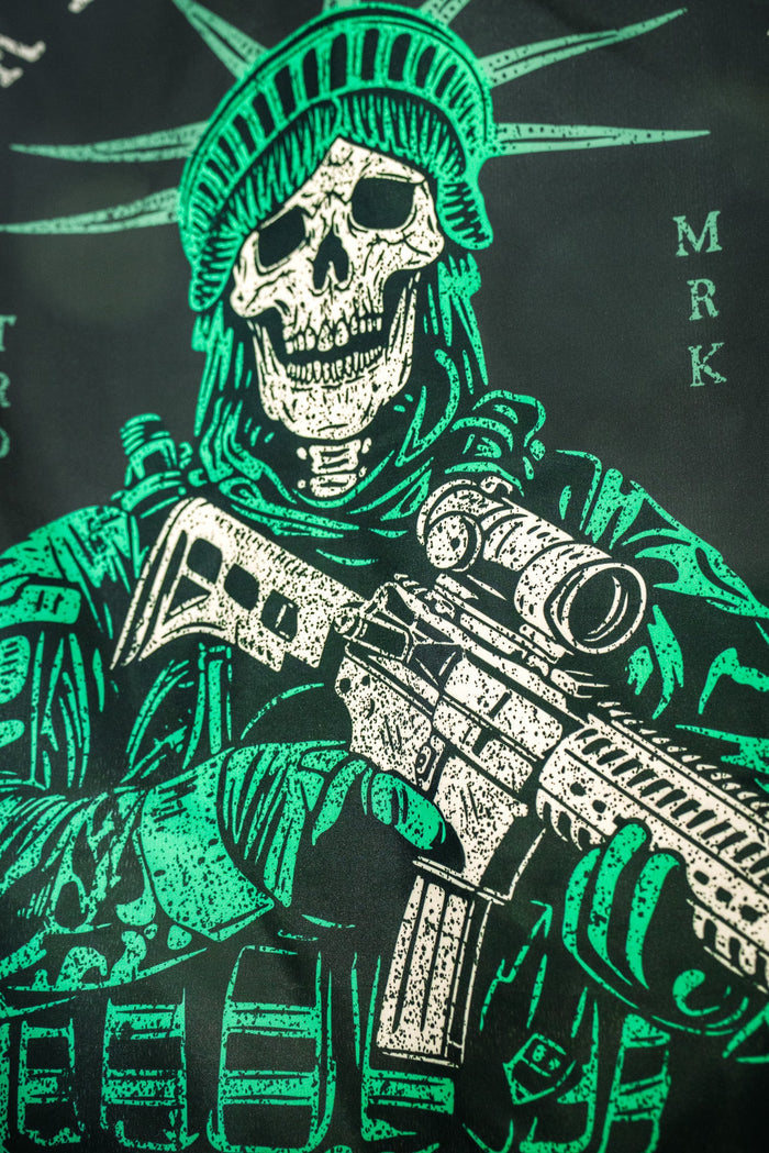 Born United Private Label’s Liberty or Death Flag features a skeleton in tactical gear with a helmet resembling the Statue of Liberty’s crown, holding a rifle in green and white against a dark background.