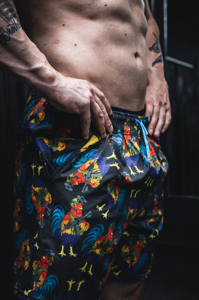 Person wearing colorful patterned shorts with a dark background