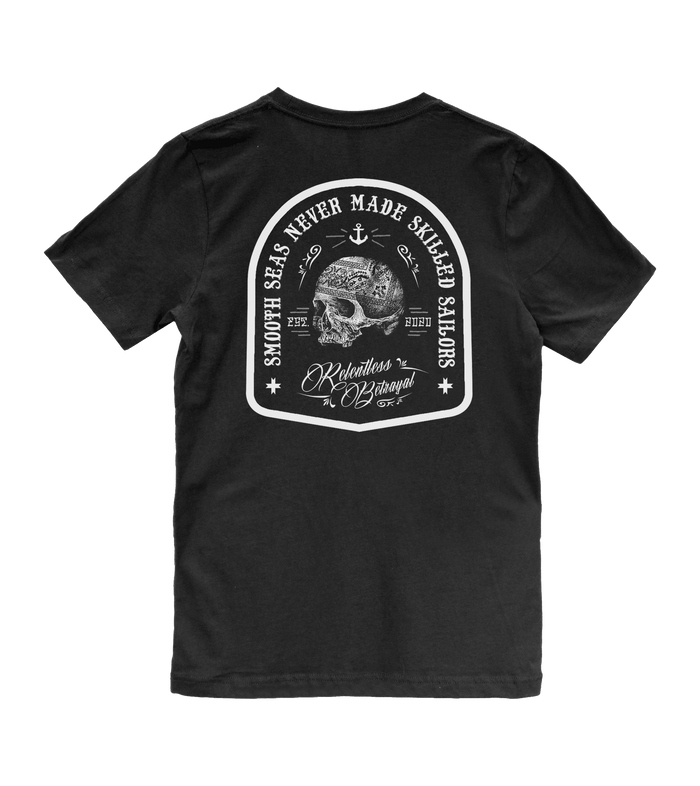The Skilled Sailor Tee by Relentless Betrayal is a black T-shirt with a white skull on the back, encircled by the phrase Smooth Seas Never Made Resilient Sailors and nautical elements like anchors. The word Relentless below embodies the spirit to overcome challenges.