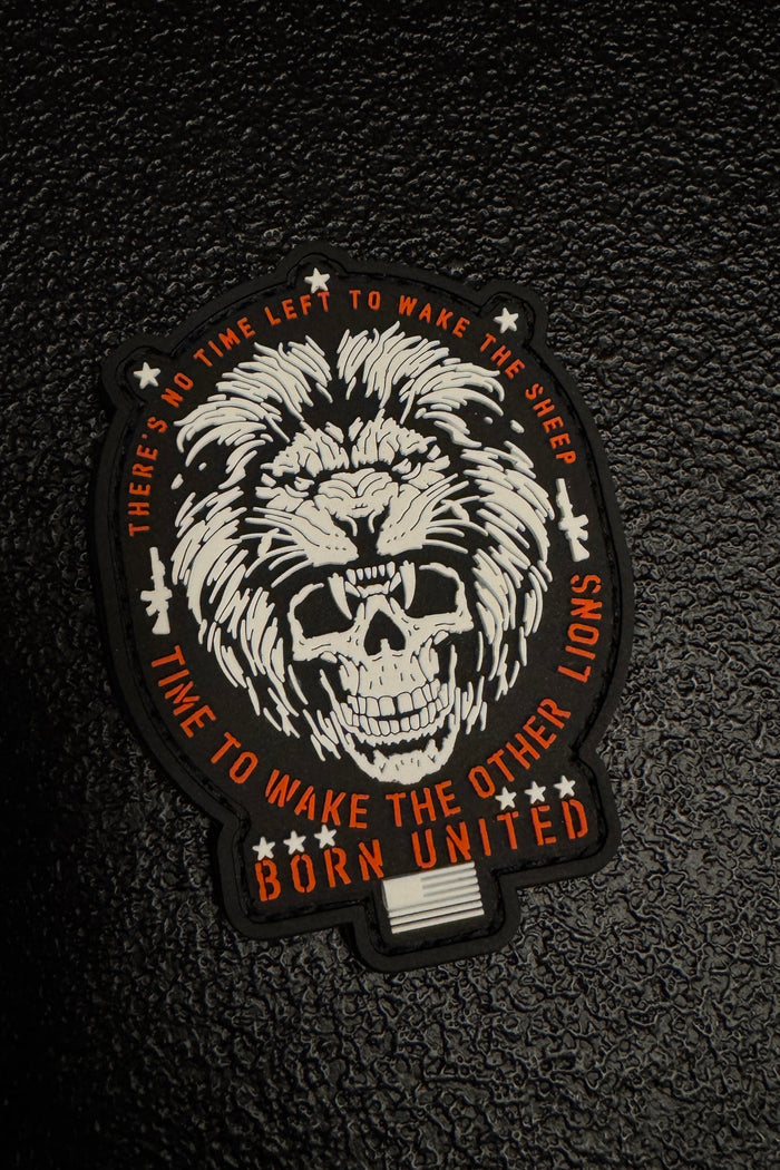 Patch with lion and skull design on a textured black background