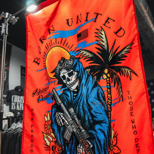 The Always Deadly Flag by Born United Private Label features a red background, a skeleton in a blue hooded robe with a rifle, palm trees, sun, and the text "Born United, For Freedom and Those Who Defend It" plus other small phrases.