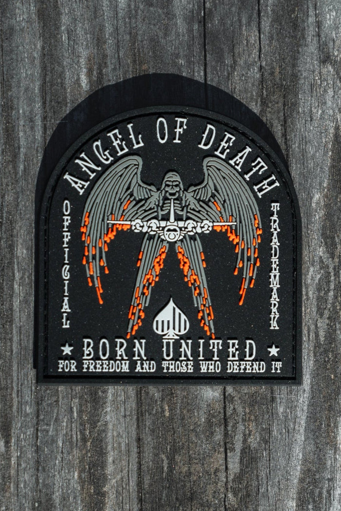 The Angel Of Death PVC Patch from Born United Private Label features a winged figure with flaming swords and the words Angel of Death and Born United for Freedom and Those Who Defend It, designed in black, white, and orange.