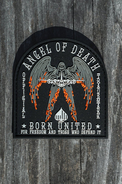 The Angel Of Death PVC Patch from Born United Private Label features a winged figure with flaming swords and the words Angel of Death and Born United for Freedom and Those Who Defend It, designed in black, white, and orange.