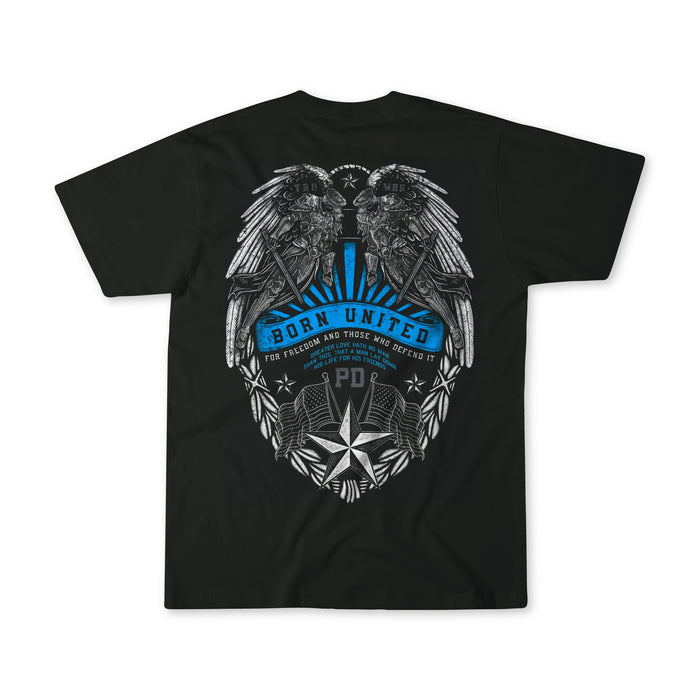 The "Back the Badge" black T-shirt by Born United Private Label features two eagles facing each other above a badge with blue accents, stars, leaves, and a "For freedom and those who defend it" banner.