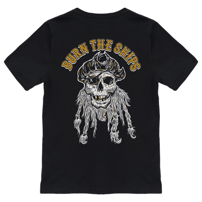 The Relentless Betrayal Burn The Ships Gold & White Tee is a unisex cotton T-shirt featuring a pirate skull in a tricorn hat, with BURN THE SHIPS in bold gold lettering.
