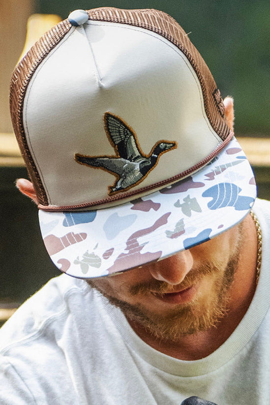 mucker bucket - camo duck bucket hat on model front