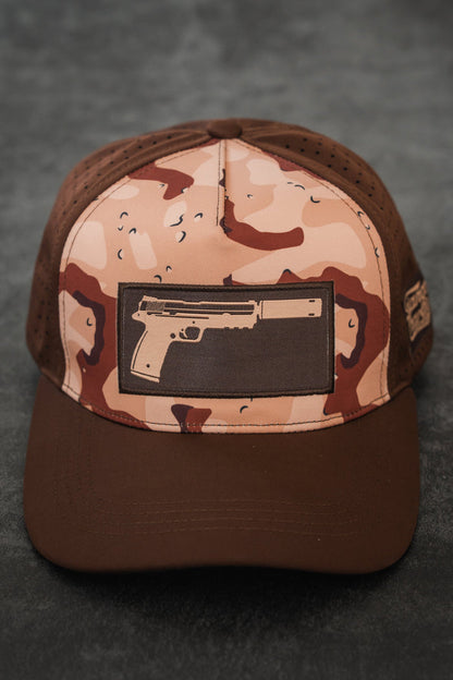 The Choco Chip Silencer Hydro Snapback Hat by Tango Charlie Apparel features a pistol with a silencer patch, brown brim, and perforated side panels for subtle style and functional detail.