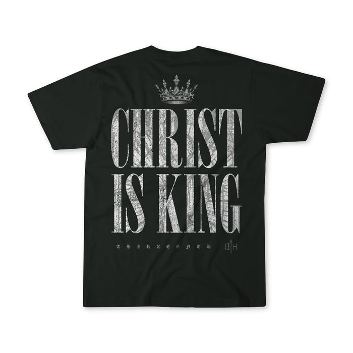 The Christ is King Premium Tee by 13th is a black shirt with a crown graphic above bold, distressed white “CHRIST IS KING” text. “THIRTEENTH” and “13TH” below honor faith in Christ the King.