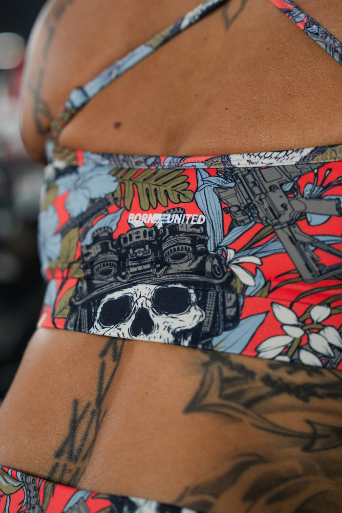 A person shows off their tattoos while wearing colorful BORN UNITED activewear and the Women's High-Waisted Seamless Front Compression Training Shorts | Tropical Chaos by Born United Private Label for an athletic look.
