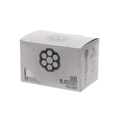 A silver box labeled Dark Roast 300 Blackout Single-Serve Shells by Caliber Coffee Company, featuring bullet and revolver cylinder illustrations. Contains 12 servings of specialty dark roast coffee, totaling 4.9 ounces (139.2 grams).
