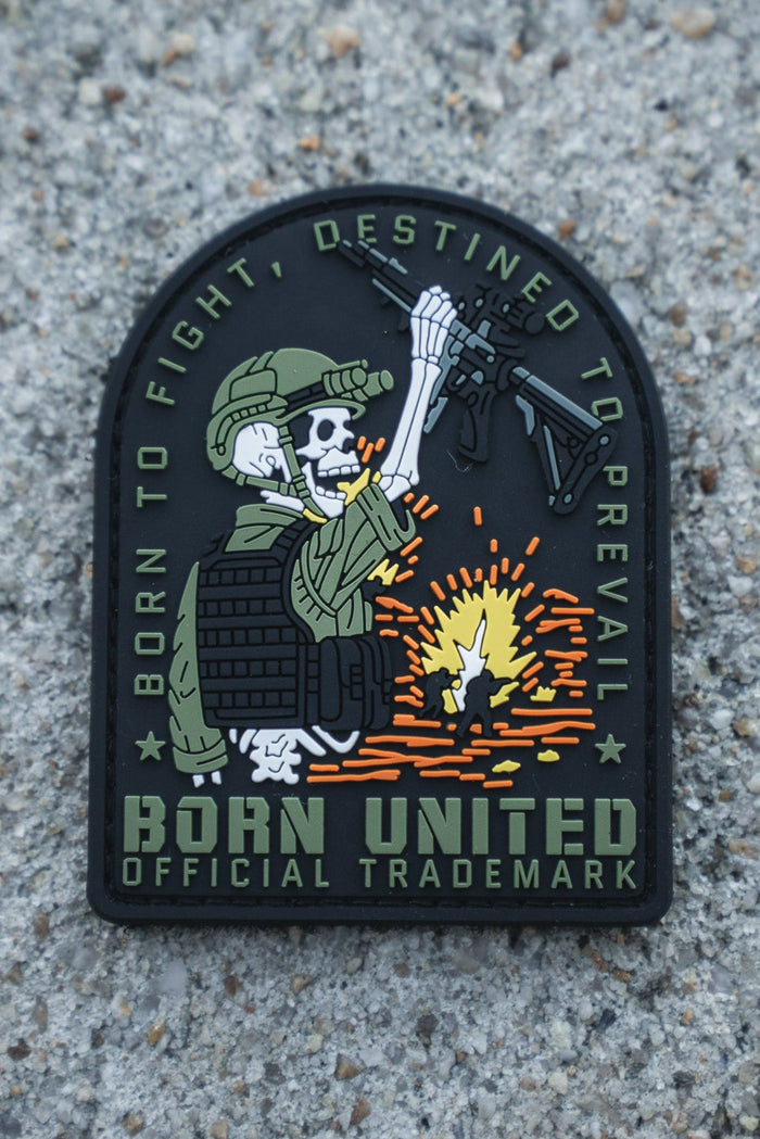 The Destined to Prevail PVC Patch by Born United Private Label shows a skeleton soldier in tactical gear with a rifle over an explosion, featuring the text "Born to fight, destined to prevail" and Born United Official Trademark on a concrete background.