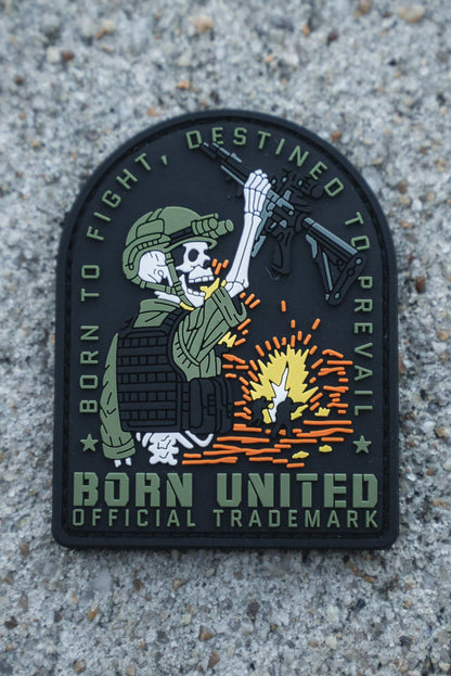 The Destined to Prevail PVC Patch by Born United Private Label shows a skeleton soldier in tactical gear with a rifle over an explosion, featuring the text "Born to fight, destined to prevail" and Born United Official Trademark on a concrete background.