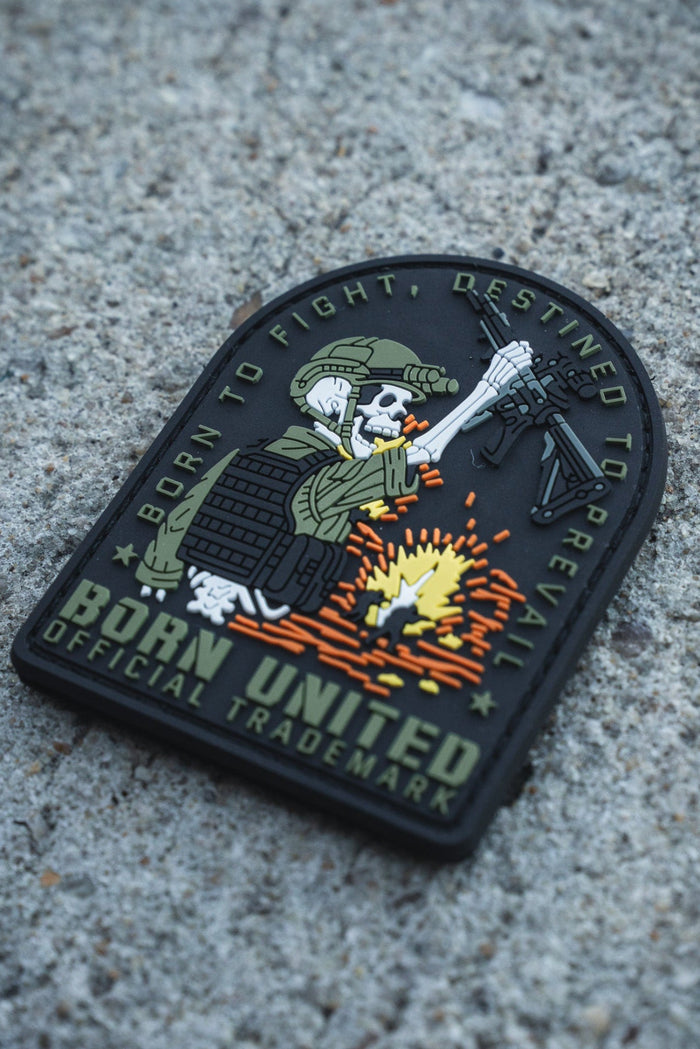The Destined to Prevail PVC Patch by Born United Private Label features a skeleton soldier in tactical gear firing a rifle, with the words: "Born to Fight, Destined to Prevail. Born United. Official Trademark.