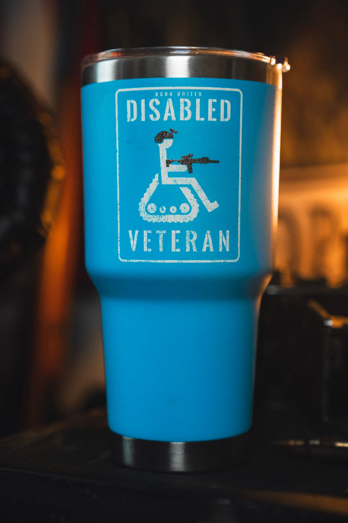 The Disabled Vet Tumbler - 30oz by Born United Private Label is a blue stainless steel tumbler with a white image of a wheelchair user holding a rifle and "Disabled Veteran" text above and below the graphic.