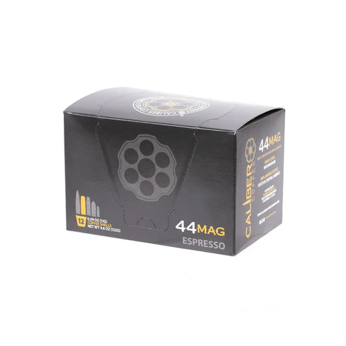The Caliber Coffee Companys Espresso Roast .44 Mag Single-Serve Shells comes in a black box designed like ammo packaging, labeled with yellow and white text and decorated with bullet cartridge illustrations. Inside, youll find 12 artisan-roasted single-serve cups.