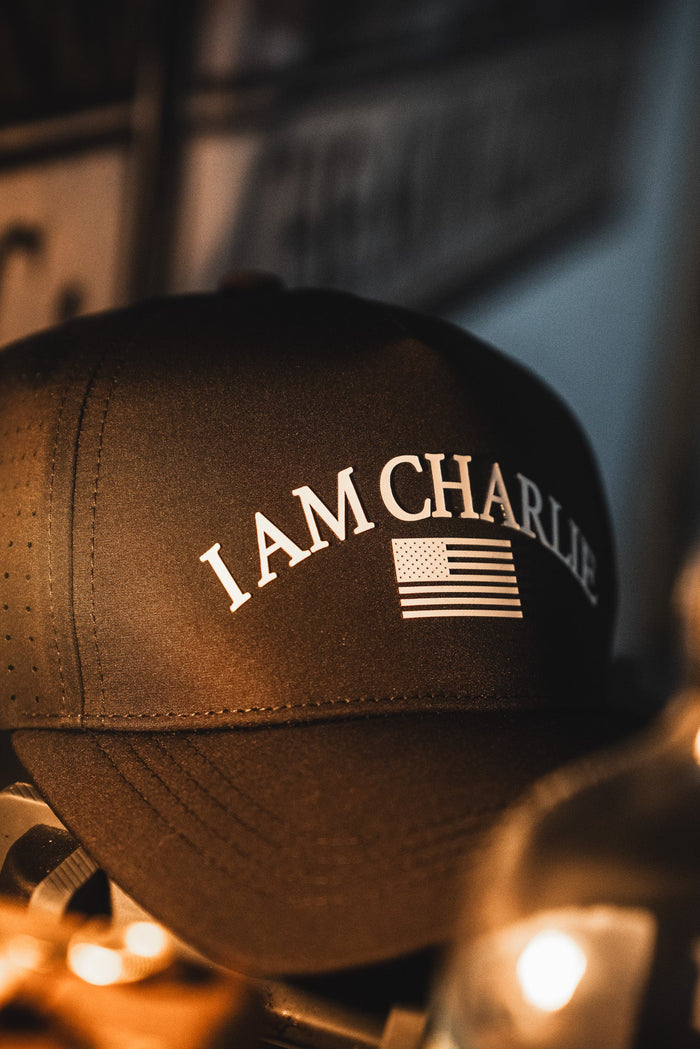 The I Am Charlie Black Snapback by Born United Private Label features "I AM CHARLIE" and an American flag on the front—a stylish choice for fans of handmade hats.