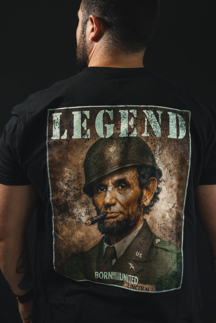 Wearing the Legend - Lincoln tee by Born United Private Label, featuring Abraham Lincoln as a soldier with a cigar and “LEGEND” above, plus “BORN UNITED LINCOLN” below—celebrating American heritage.