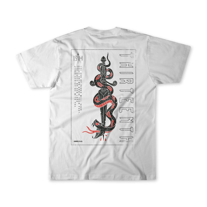 Lucifers Demise Premium Tee by 13th features a white base with a black and red snake design on the back. THIRTEENTH is vertically aligned to the right of the serpent, symbolizing the God of Peace. The left side displays a calendar-style layout with 13TH at the top.