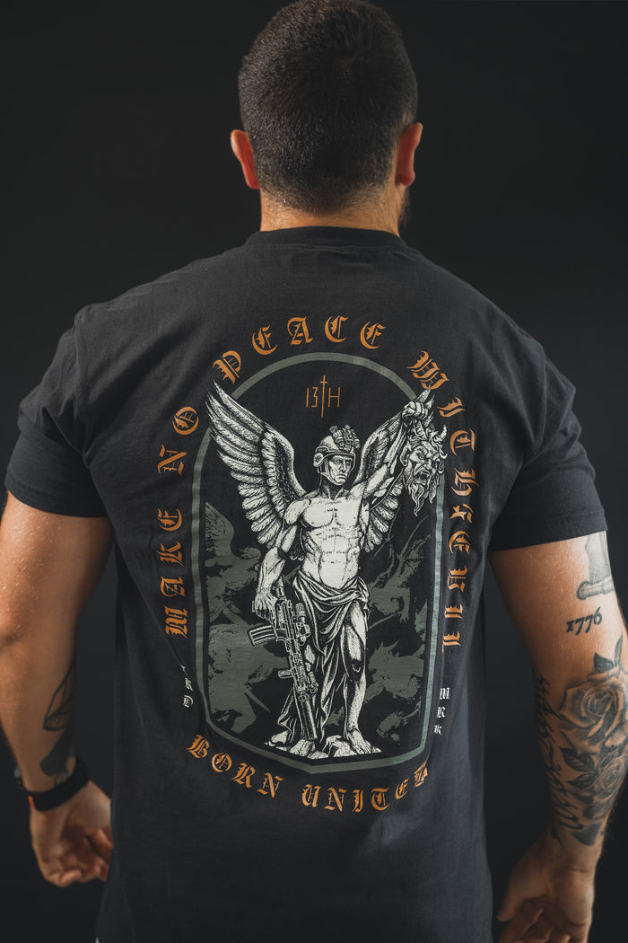 A man faces away wearing the Make No Peace Premium Tee by Born United Private Label—crafted from premium cotton, it features a winged warrior with sword and head, plus "MAKE NO PEACE WITH THE 13TH BORN UNITED" boldly printed on the back.