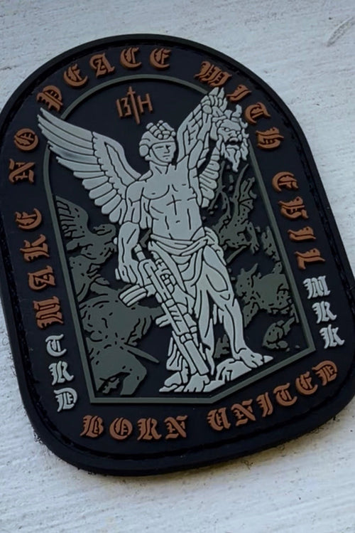 The Make No Peace PVC Patch by Born United Private Label features an angel with a sword and severed head, plus inscriptions "MAKE NO PEACE WITH EVIL," "BORN UNITED," and "TIRDJ MRK 13TH"—ideal for custom patch collectors.