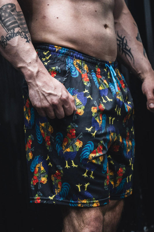 Person wearing colorful patterned shorts with a dark background