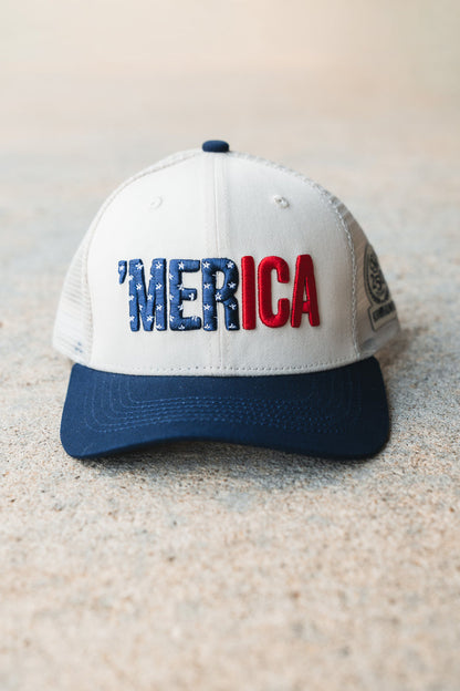 The Born United Private Label ’Merica Trucker Snapback is a white and blue trucker hat featuring “MERICA” embroidered on the front in blue stars and red letters. This breathable snapback blends classic style with all-day comfort.