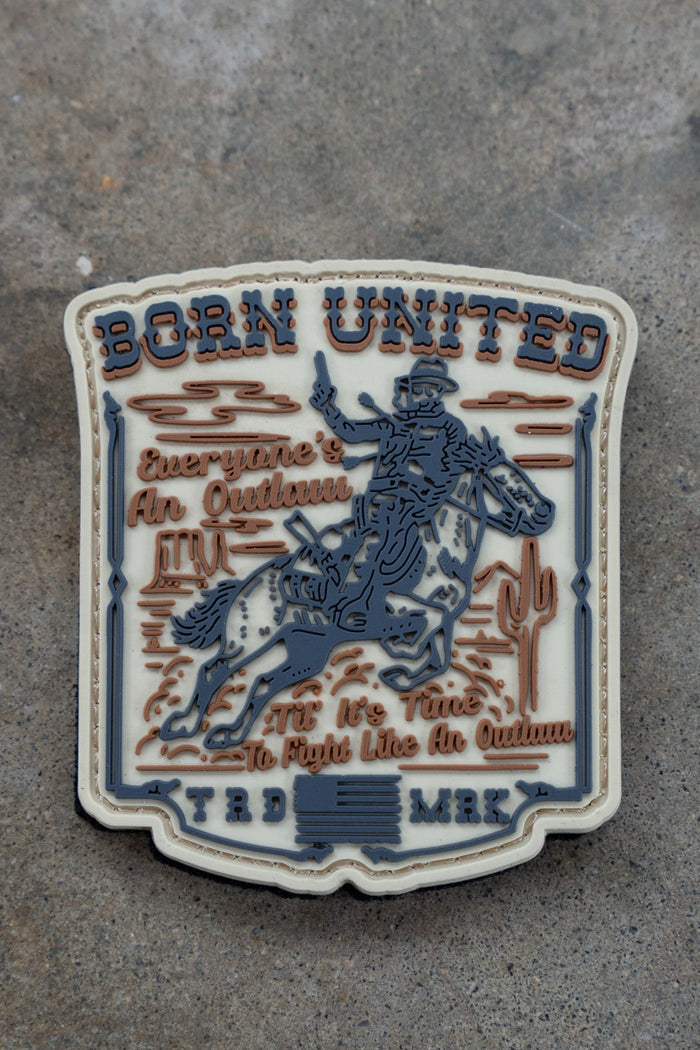 The Outlaw PVC Patch by Born United Private Label shows a cowboy on horseback with cacti, plus “BORN UNITED” and “Everyone’s An Outlaw. It’s Time To Fight Like An Outlaw. TRD MRK.” in bold text.