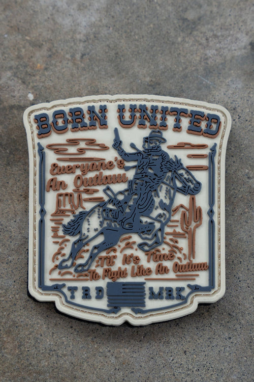 The Outlaw PVC Patch by Born United Private Label shows a cowboy on horseback with cacti, plus “BORN UNITED” and “Everyone’s An Outlaw. It’s Time To Fight Like An Outlaw. TRD MRK.” in bold text.