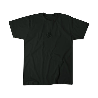 The Overcome Premium Tee by 13th is a black T-shirt with a minimalist design, showcasing a central white 13H logo. The fabric is soft and slightly wrinkled, symbolizing youthful strength to overcome challenges and embrace faith.