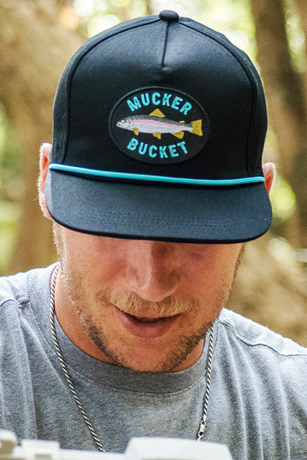 mucker bucket - rainbow trout bucket hat on model front view
