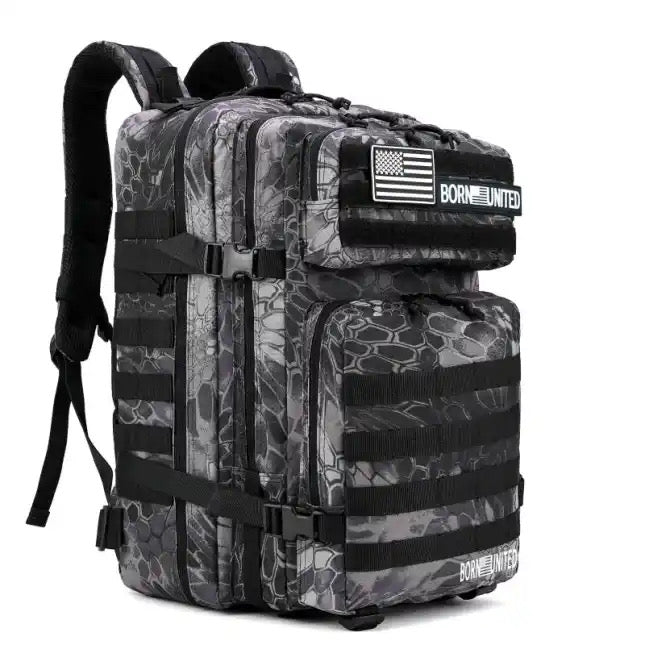 The Born United Private Label Standard Tac-Pac Ultimate Bundle is a black and gray camouflage tactical backpack with multiple compartments, straps, and front patches featuring an American flag and "BORN UNITED.