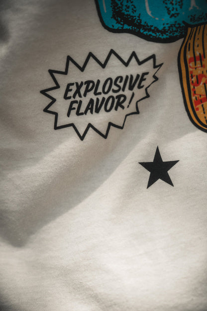 Close-up of a white Sweet Victory fabric by Born United Private Label, featuring a black star and a comic-style speech bubble reading "EXPLOSIVE FLAVOR!" in bold letters beside a partial colorful object.
