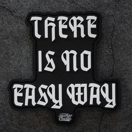 The There’s No Easy Way - Patch by Tango Charlie Apparel is a black 3-inch patch with bold white gothic lettering reading “THERE IS NO EASY WAY” on a textured gray background.