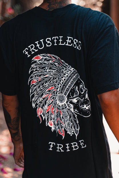 A person in the Relentless Betrayal Trustless Chief RED T-Shirt, a unisex black and red tee with a skull in a Native American headdress and “TRUSTLESS TRIBE” text—this fine jersey cotton shirt fuses edgy style with comfort.